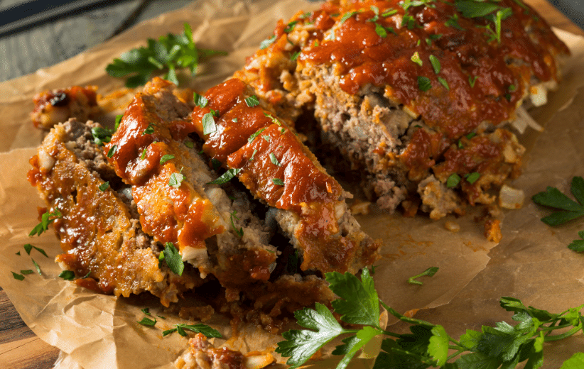 Juicy meatloaf made with grass-fed ground beef from Old Time Farm, topped with savory sauce and herbs