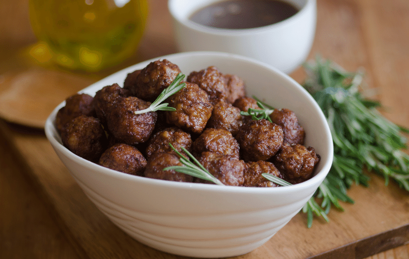 Delicious meatballs made from Old Time Farm Grass-fed Ground Beef, served in a bowl with herbs